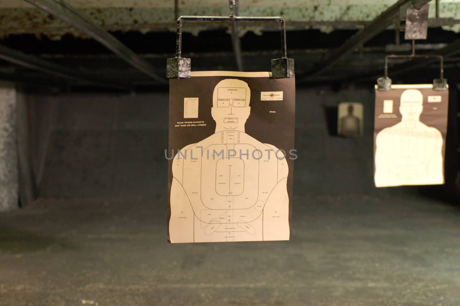 Paper 'police' style target of a man's head and shoulders at a shooting range