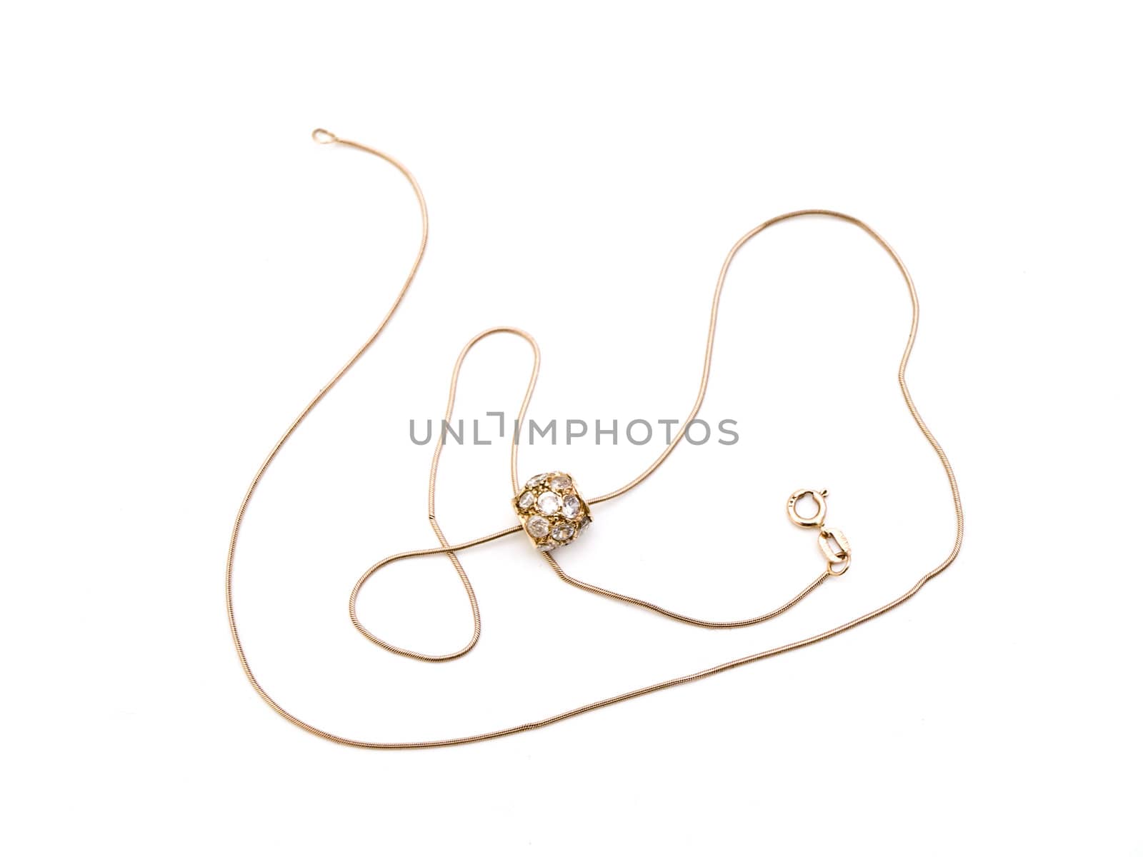 Golden necklace with pendant against the white background