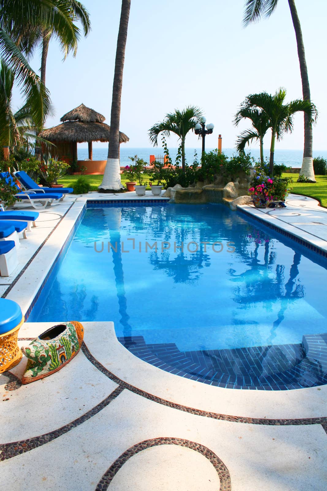 Luxury tropical pool overlooking cabana and ocean
