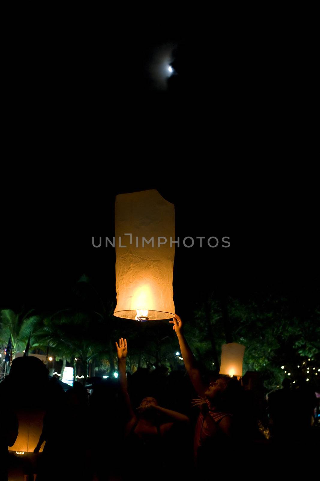 Lighting the lanters at Buddhist festival of Loy Krathong in Phuket,Thailand