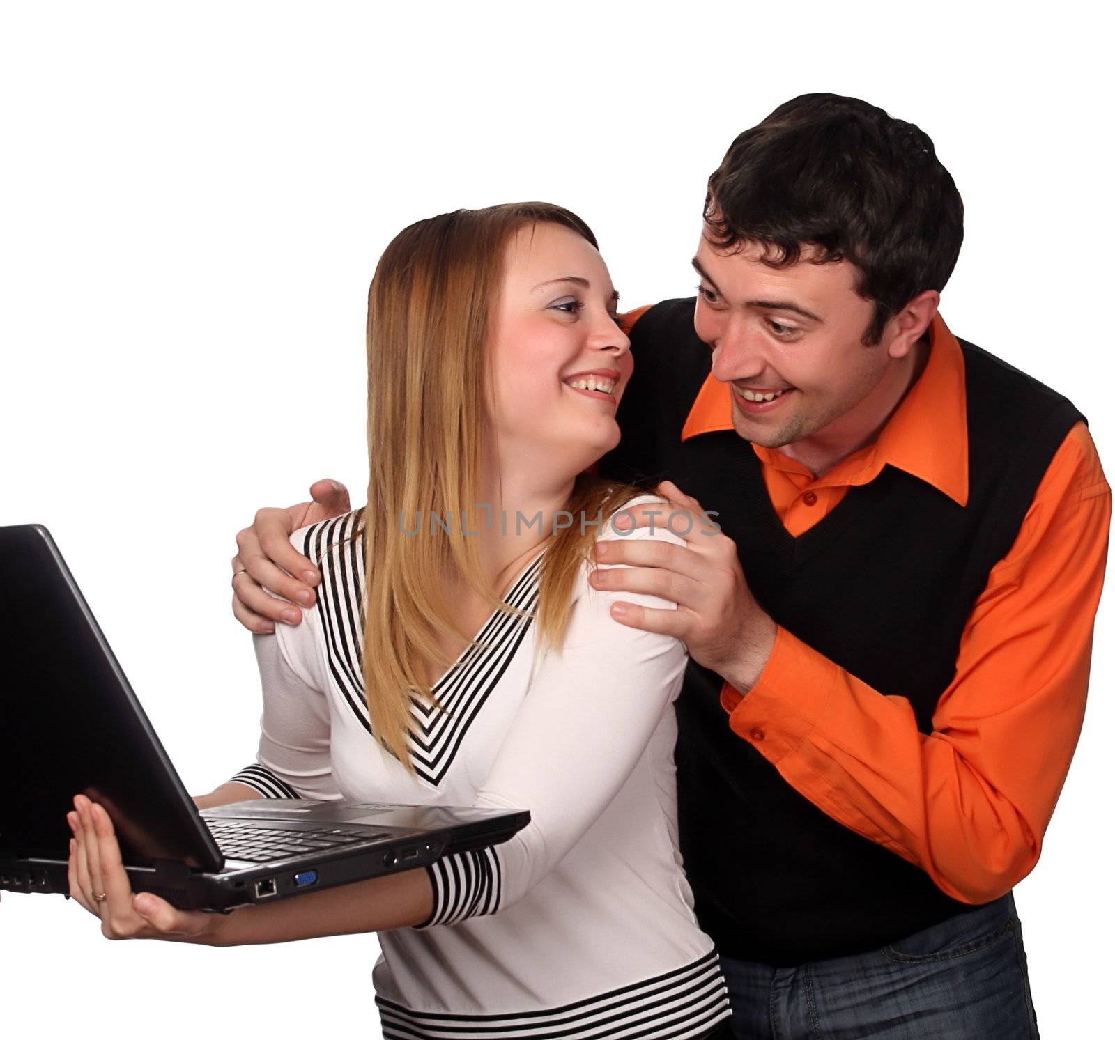 couple having fun with laptop, pretty blonde and handsome young dark haired man