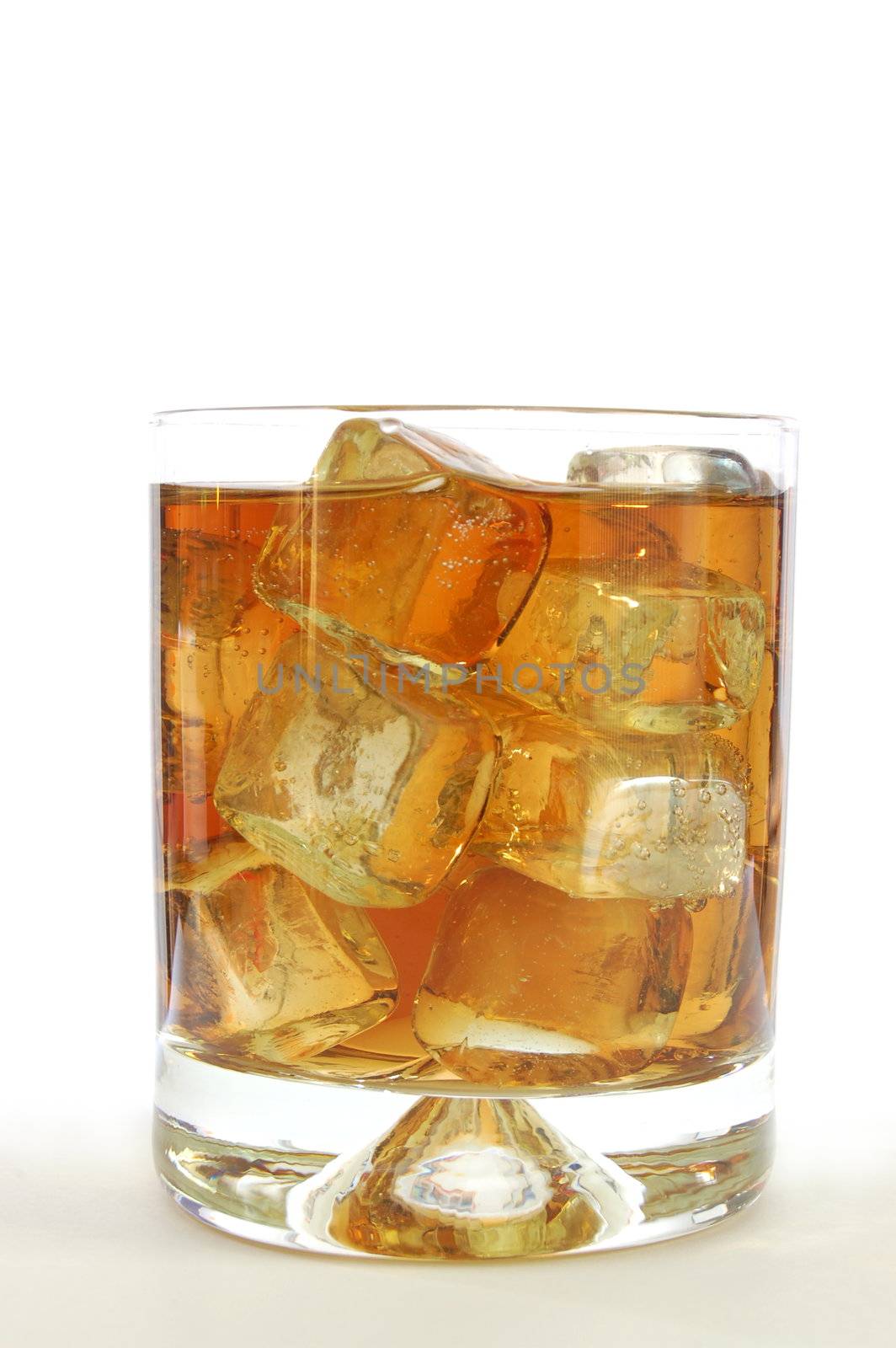 glass of whisky on the rocks isolated on white