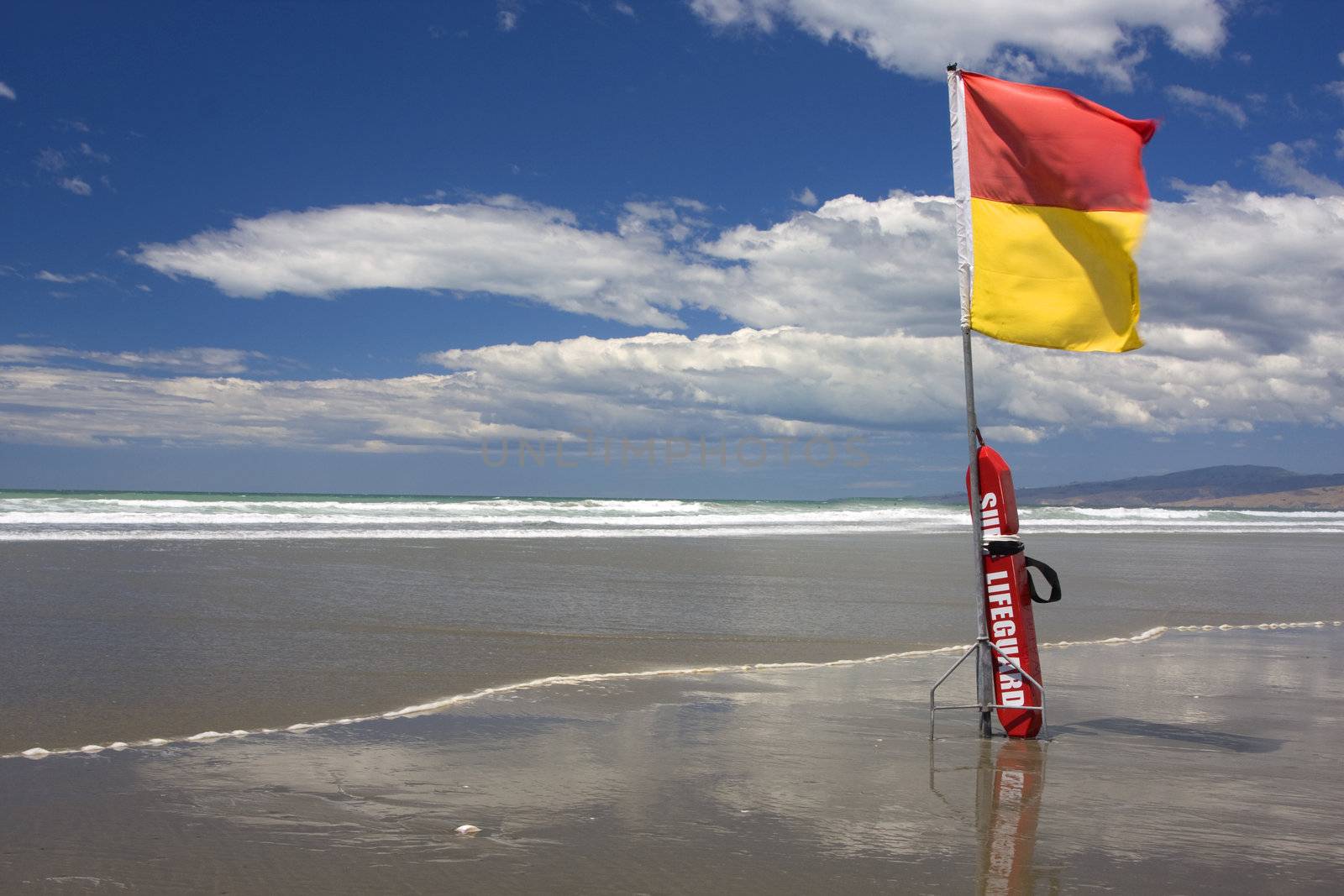 Surf Lifesaving flag and buoyancy aid on a New Zealand Beach