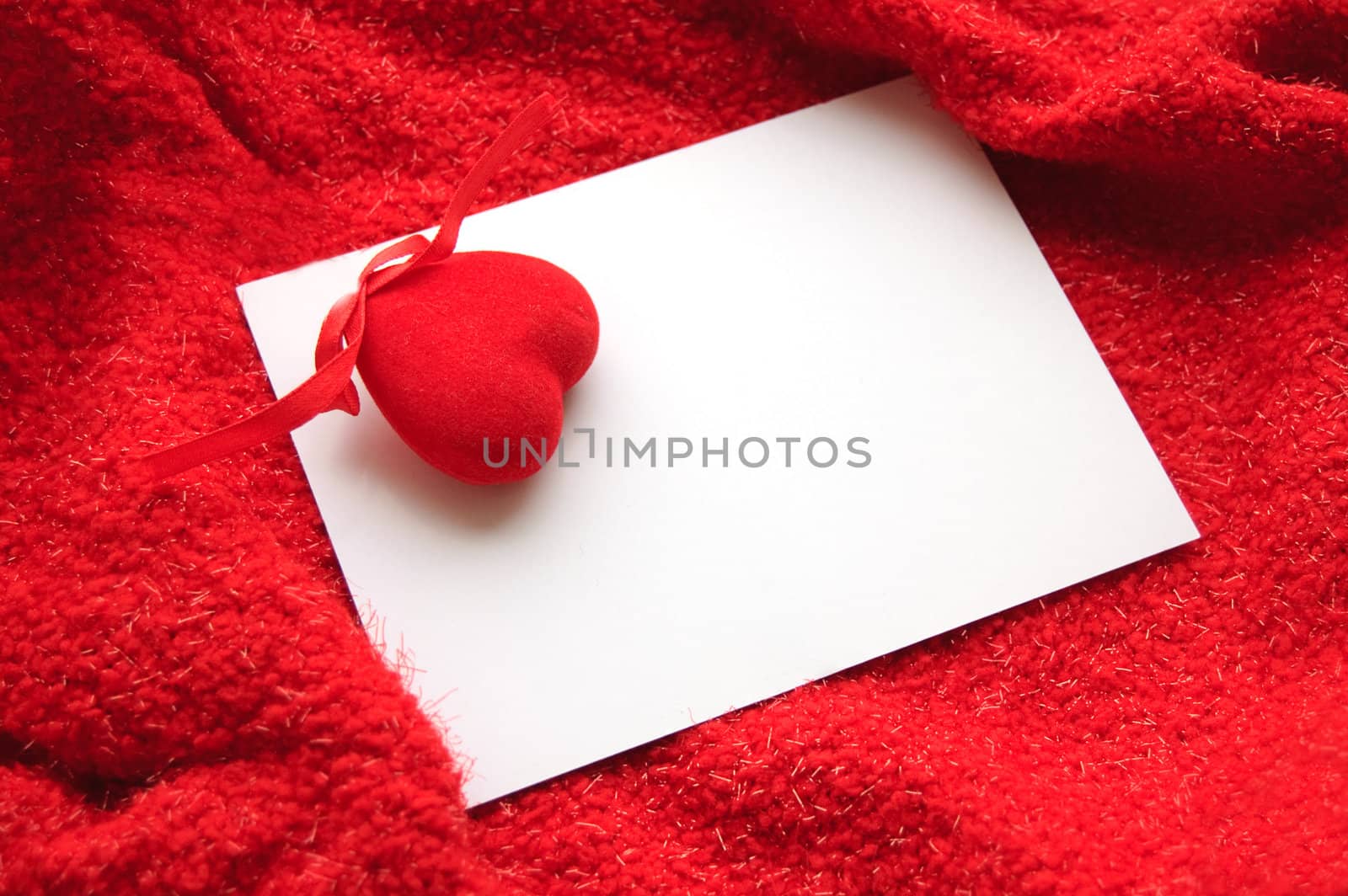 White blank note with red heart on red background