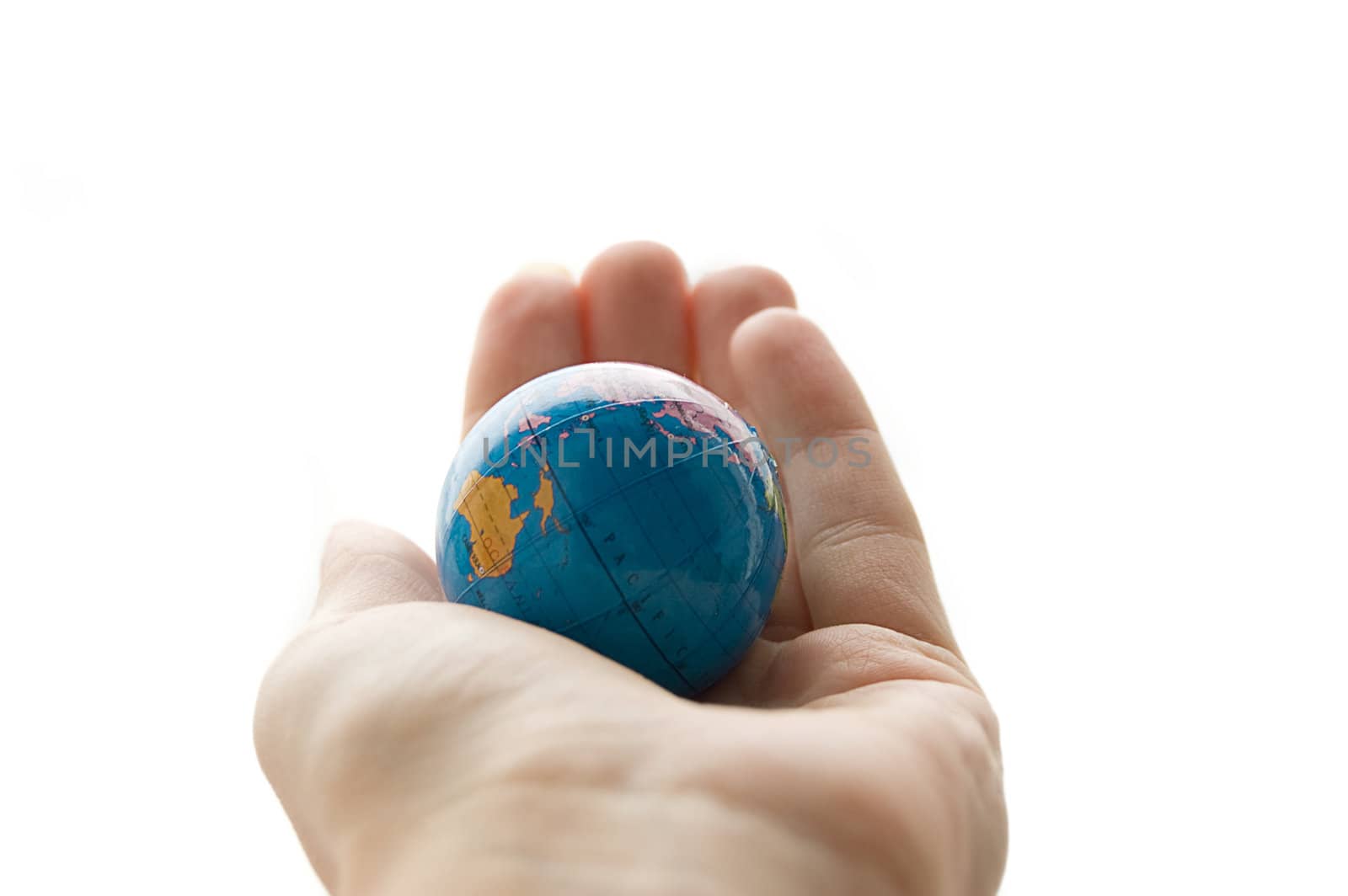 Globe in human palm isolated on white