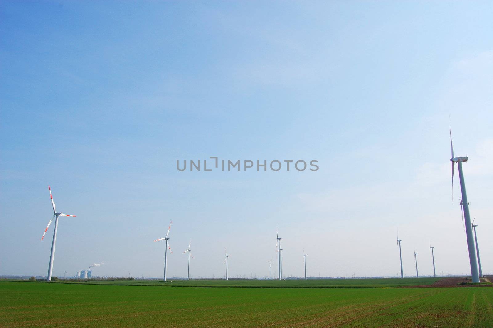 wind turbine under blue sky for alternative energy