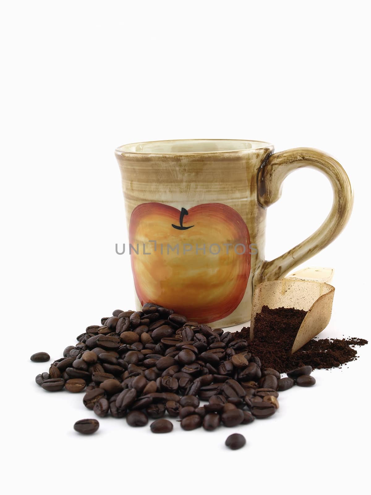 Dark roasted coffee beans and fresh ground coffee in a scoop with a coffee cup on a white background.