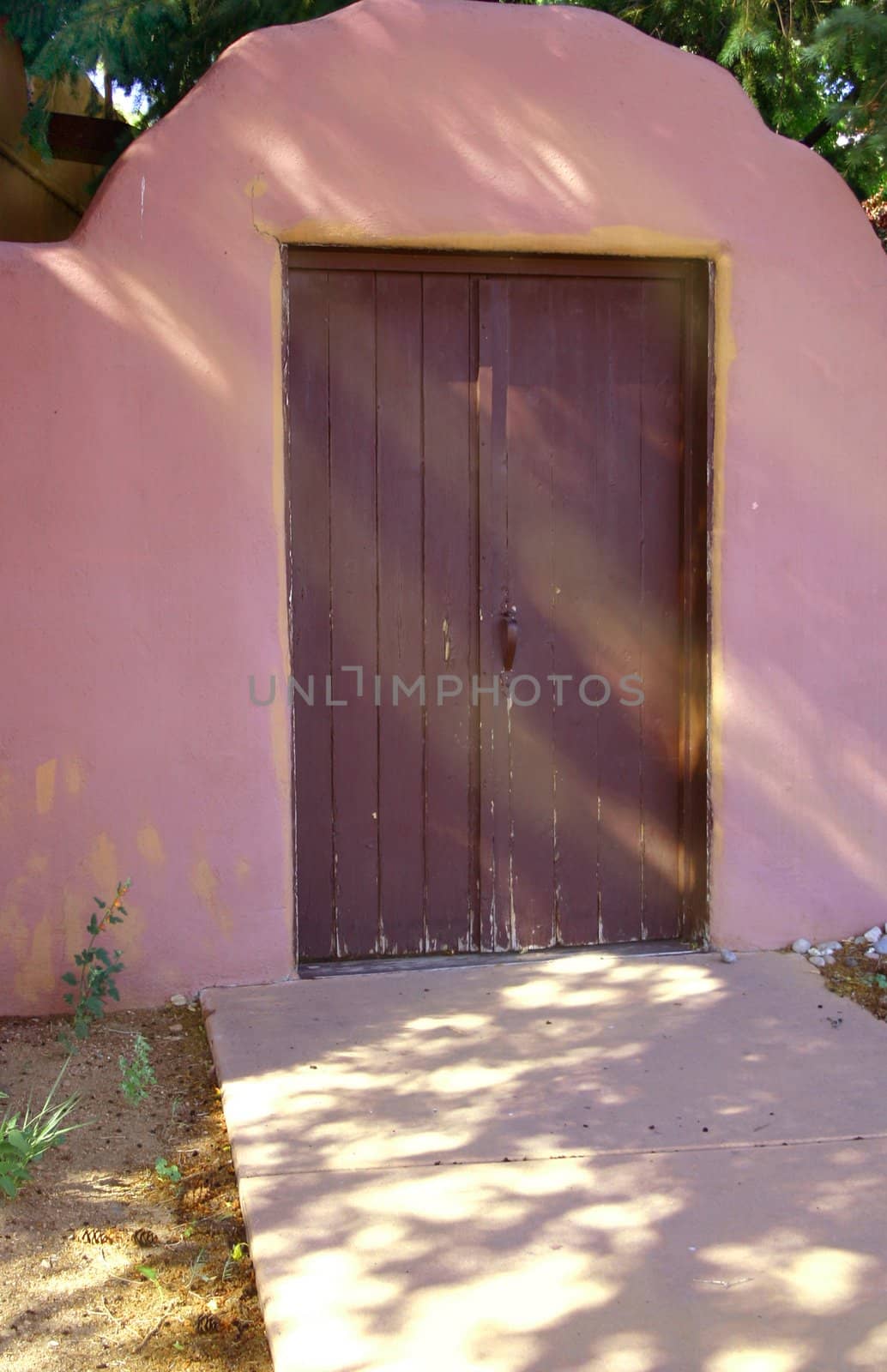 A beautiful southwestern doorway enters into a shady courtyard which offers respite from the sunshine and heat of the desert.