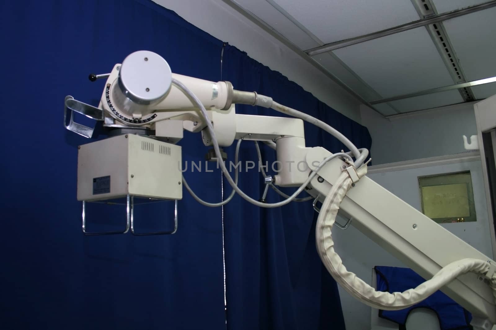 x-ray machine arm inside a medical facility
