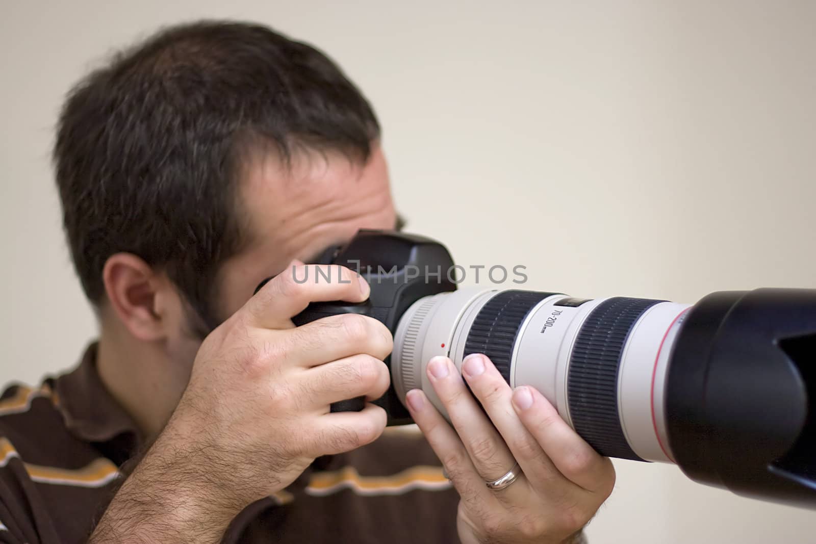 A photographer shooting with a telephoto lens.  Shallow depth of field.