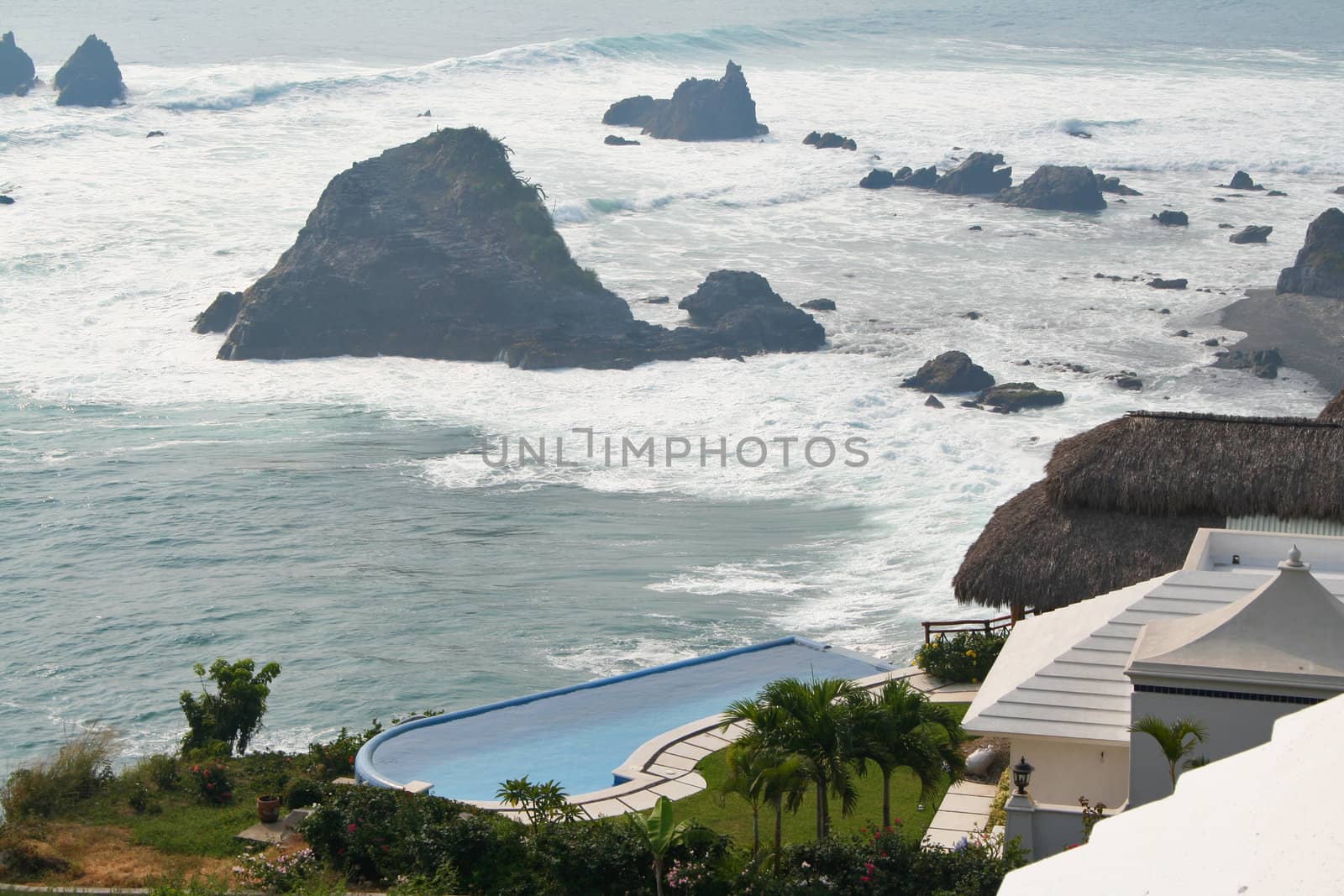 Luxury tropical pool overlooking ocean