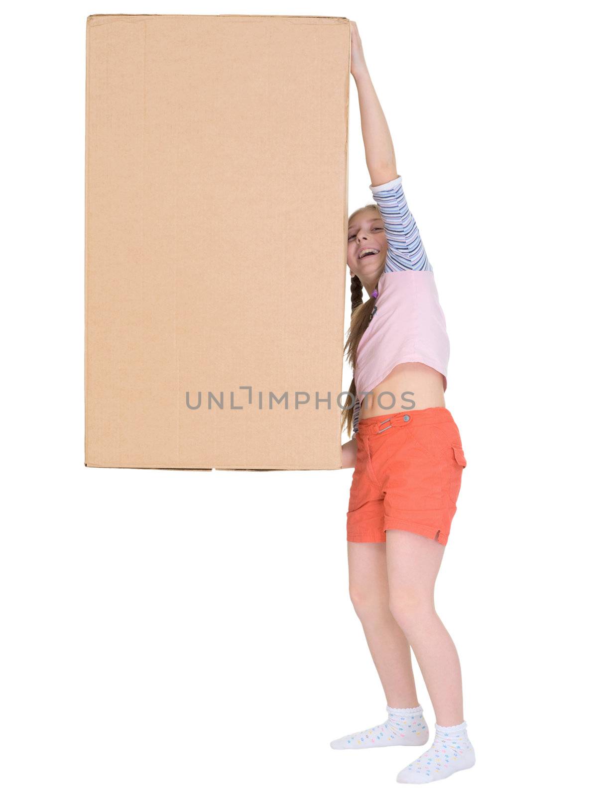 The small cheerful girl drags the big cardboard box isolated on white