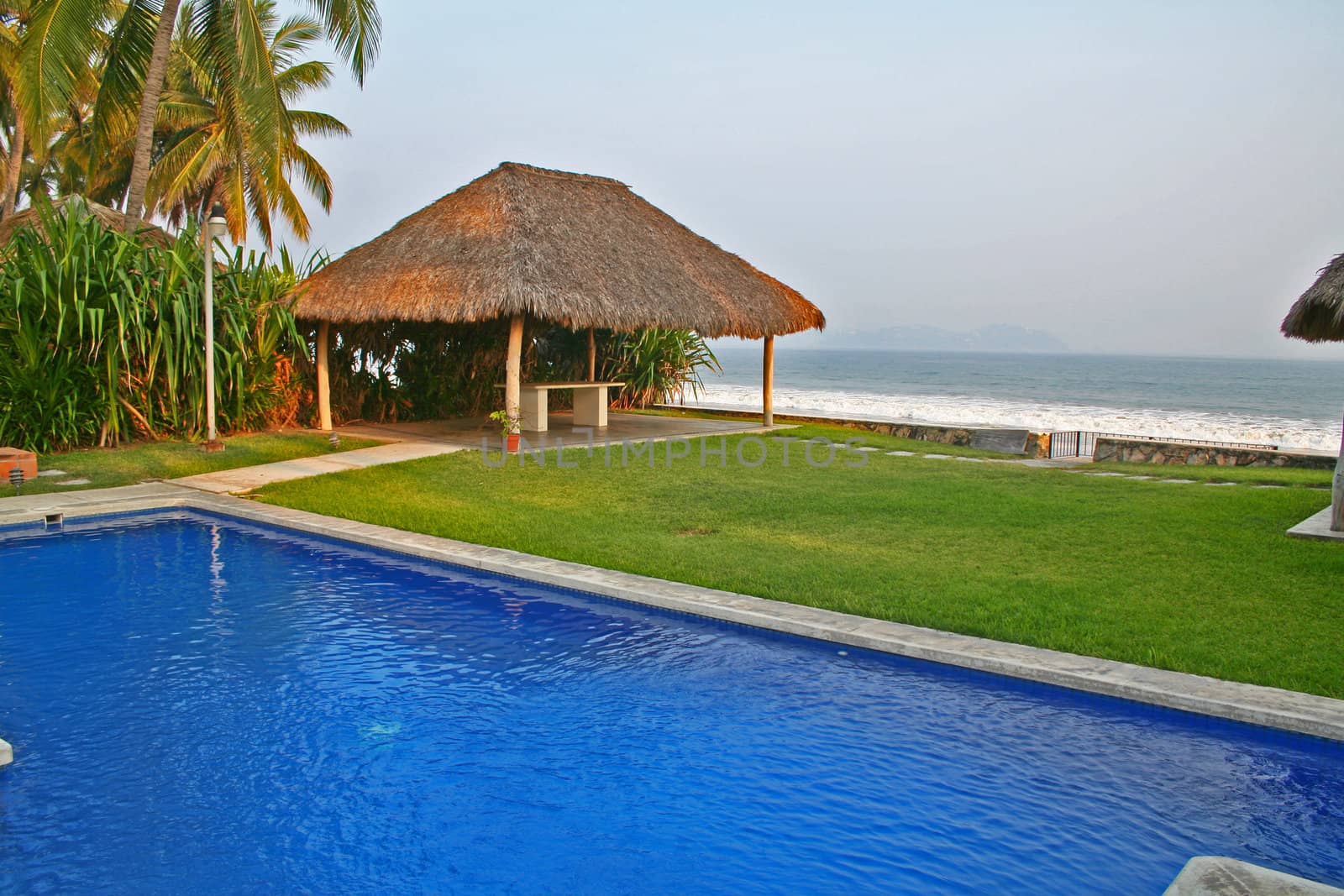 Luxury tropical pool overlooking ocean and cabana