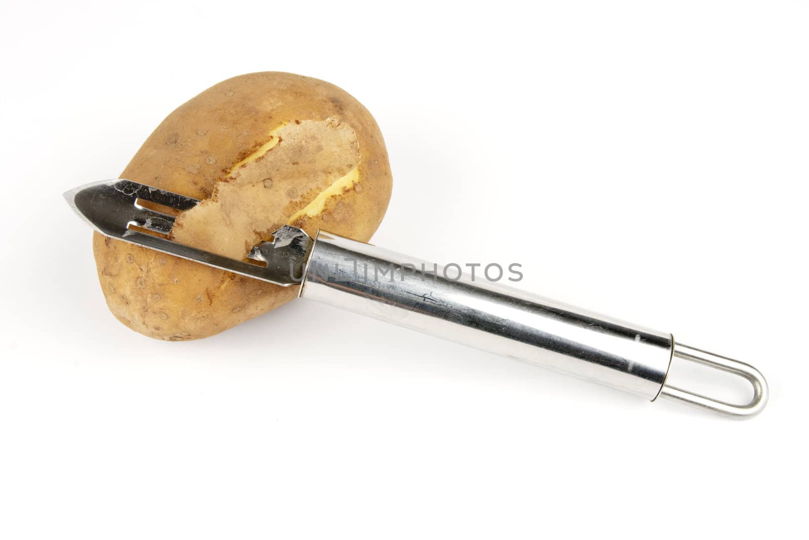 Small brown raw potato with chrome peeler on a reflective white background