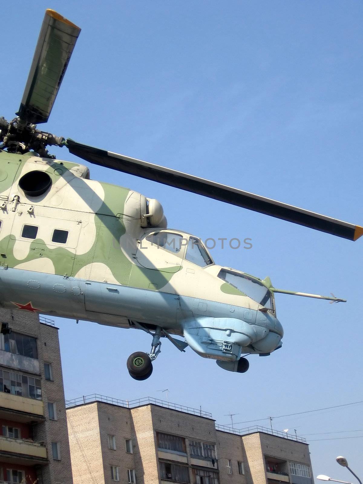 Helicopter at the pedestal on a background of blue sky