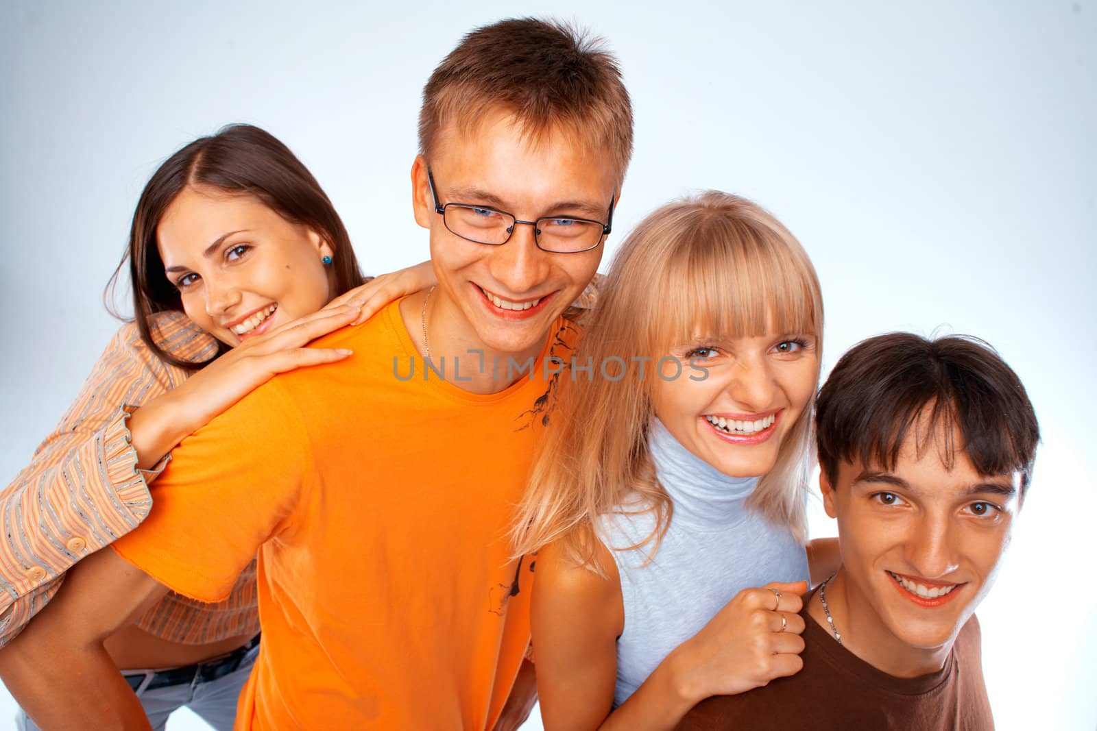 Young friends laughing together standing in a row
