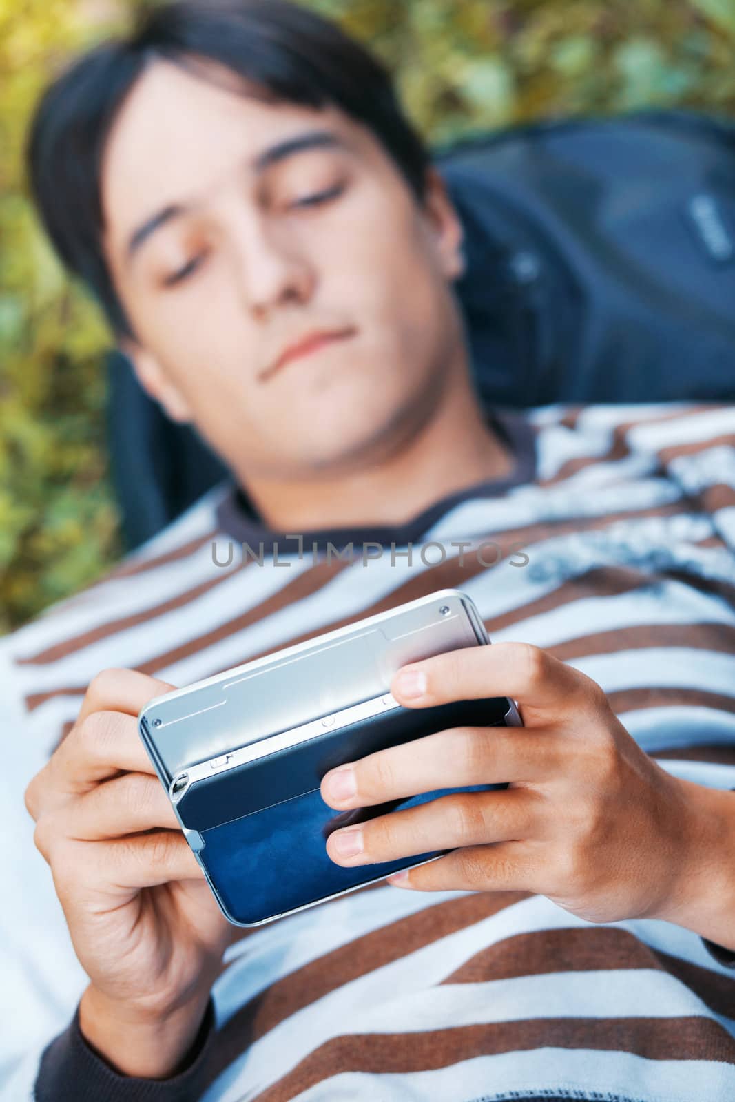 Young man with his pocket computer by romanshyshak