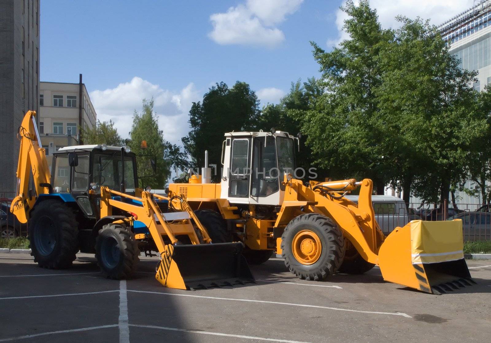 two bulldozer on asphalt road