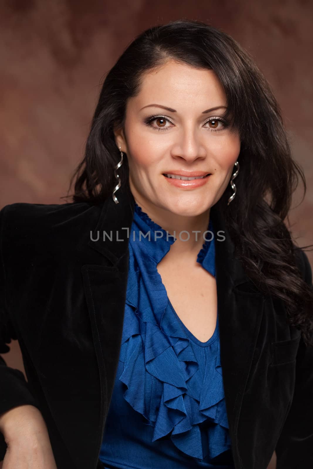 Attractive Hispanic Woman Poses for an Inside Studio Portrait.