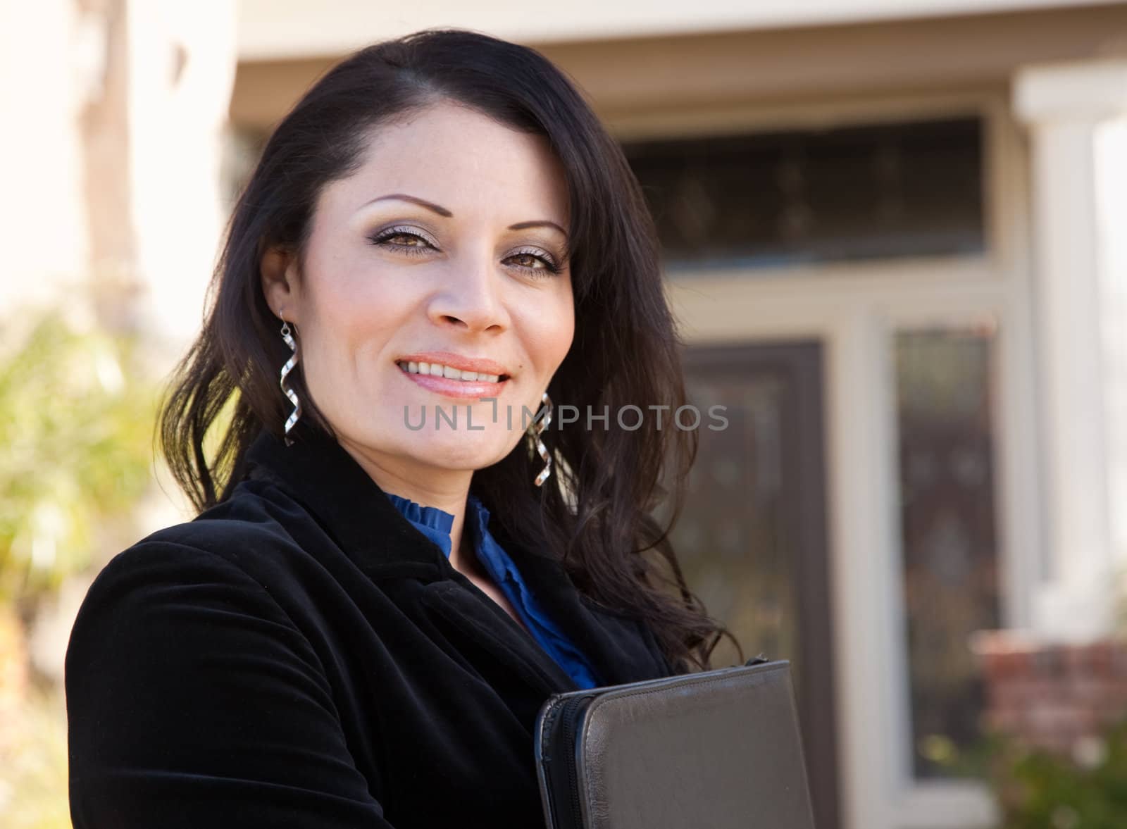 Proud, Attractive Hispanic Real Estate Agent Woman in Front of New Home.