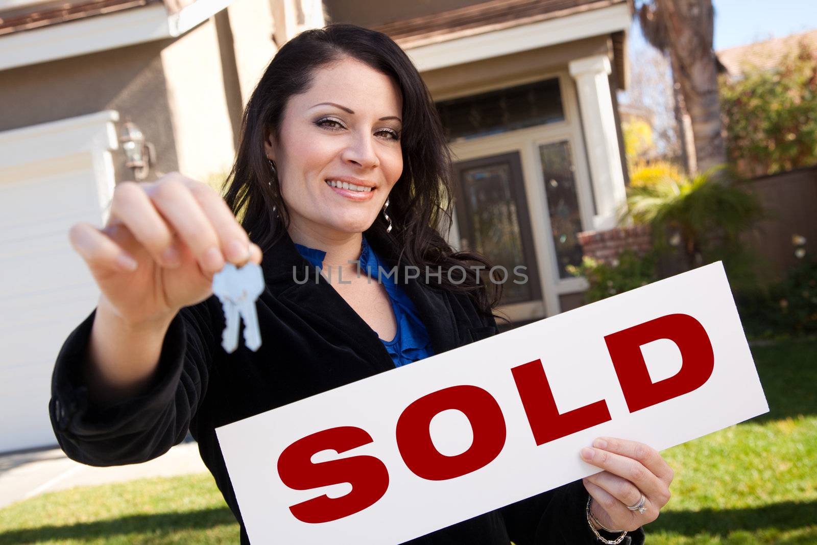 Hispanic Woman Holding Keys and Sold Sign In Front of House by Feverpitched