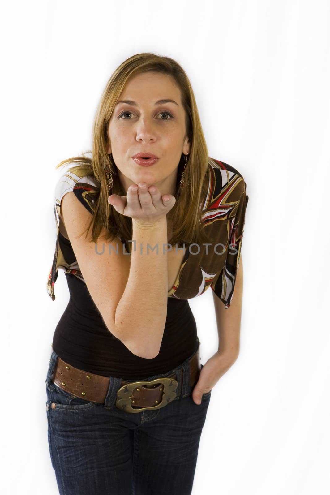 Beautiful young woman blowing kisses against white background