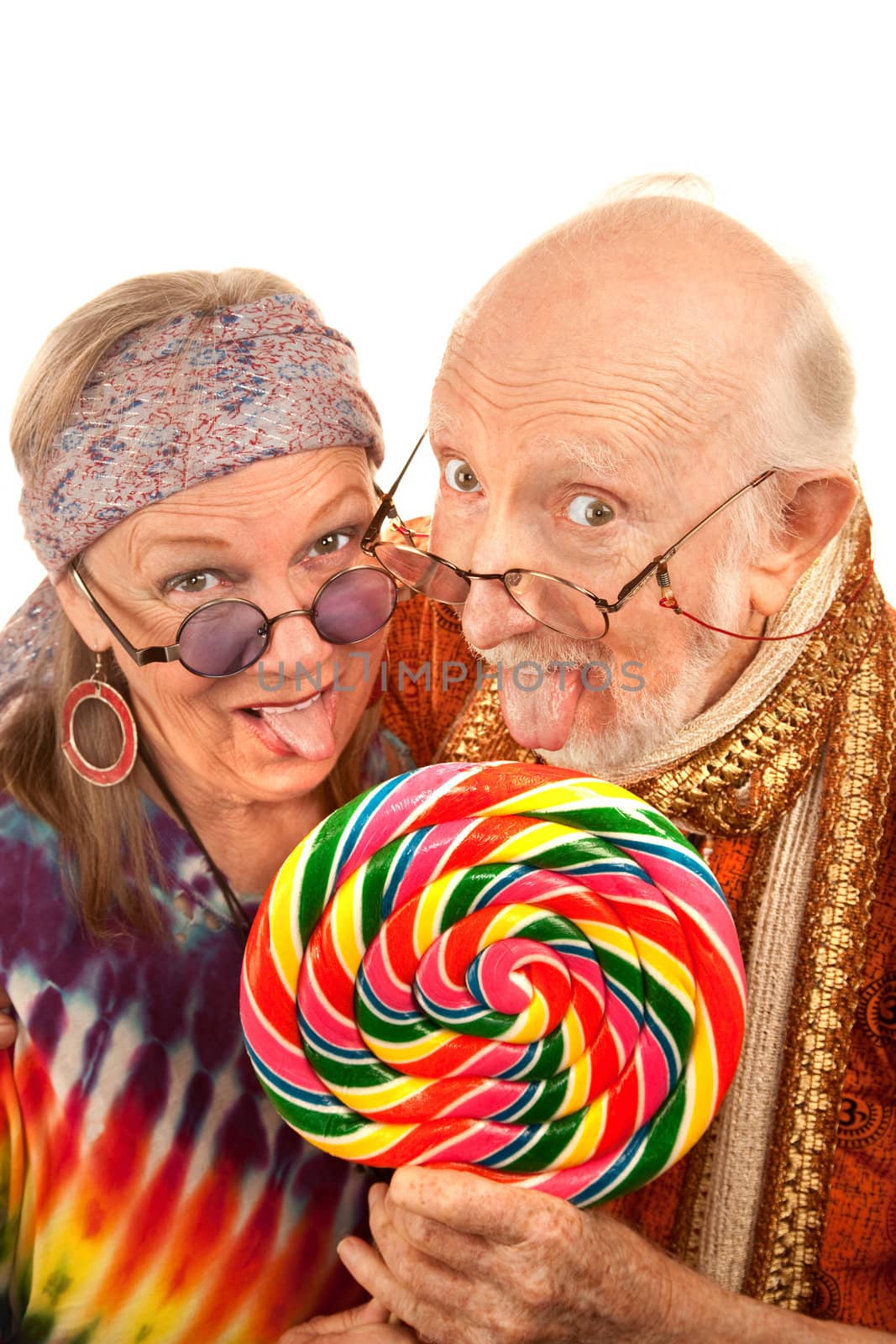 Portrait of hippie seniors licking a large lollipop