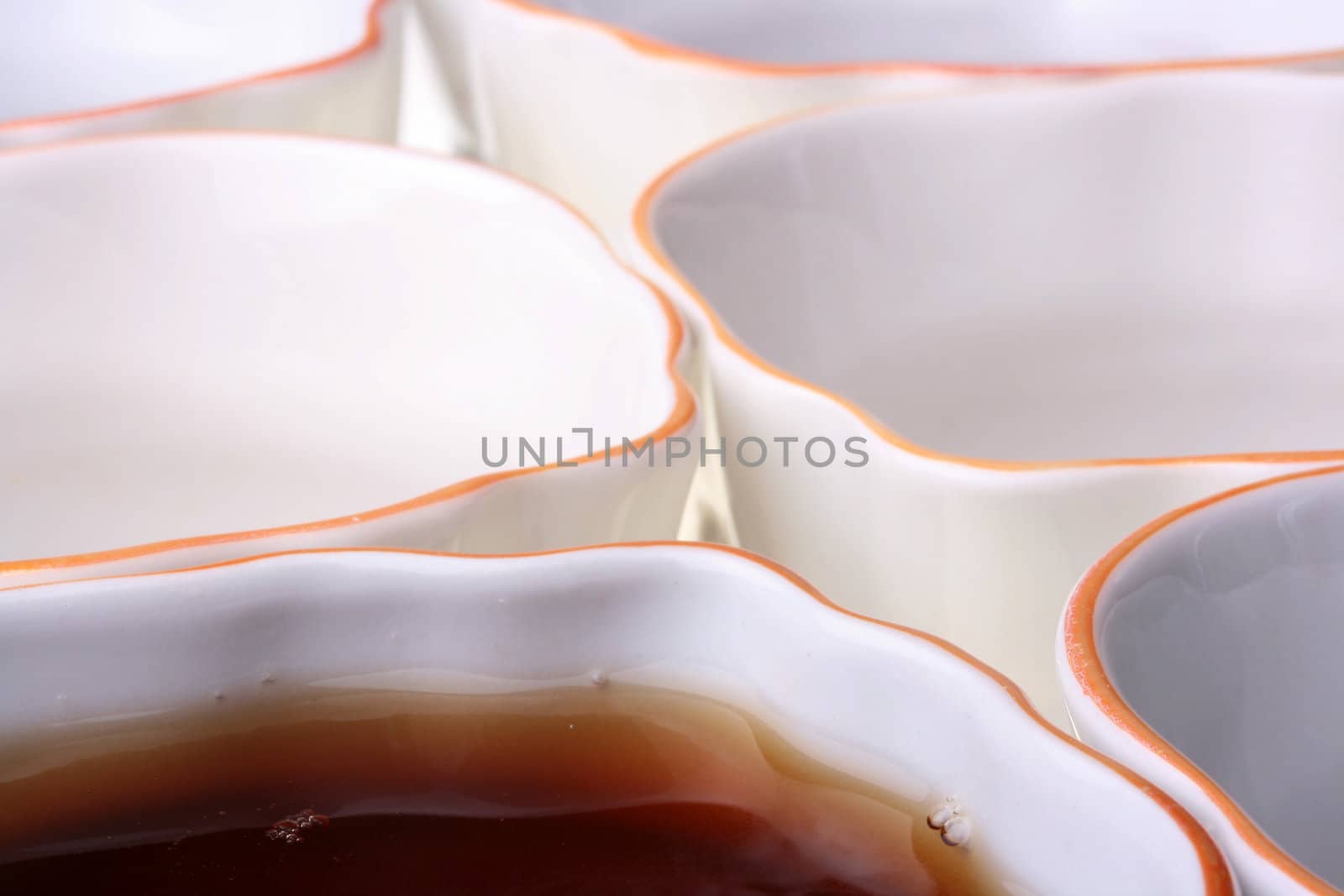 Tea cups in one of cups black tea, a theme of restaurant or cafe.