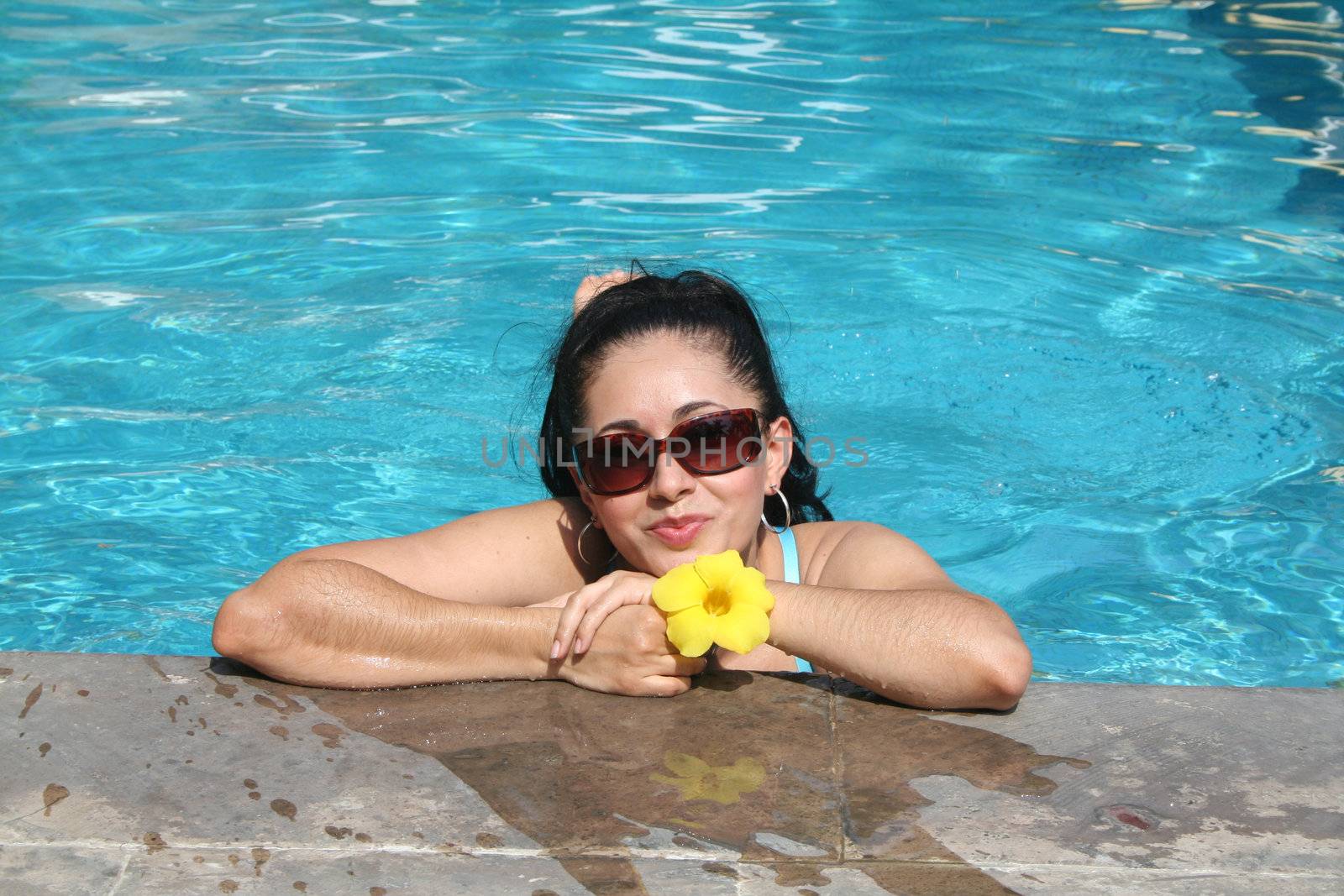 Young latin woman in pool