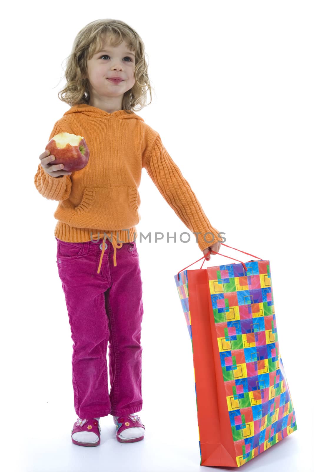 Beautiful little girl with aple on isolated background