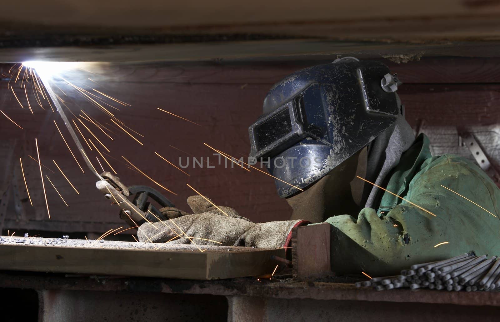 a welder working at shipyard during night shift