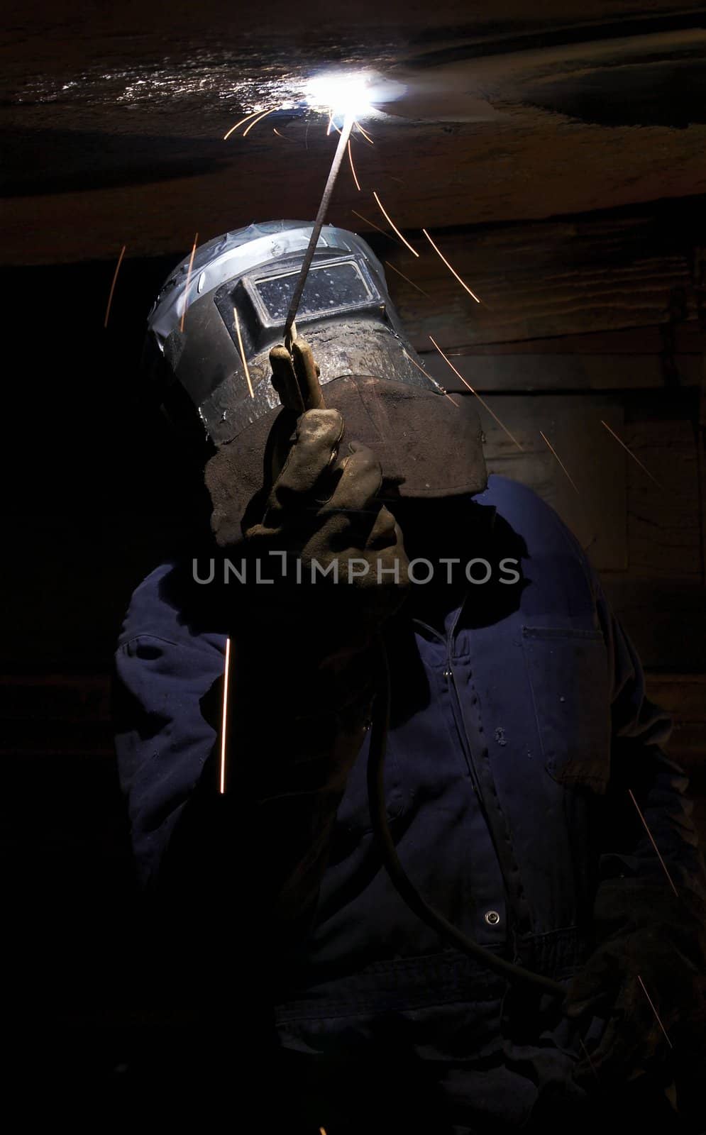 a welder working at shipyard at night