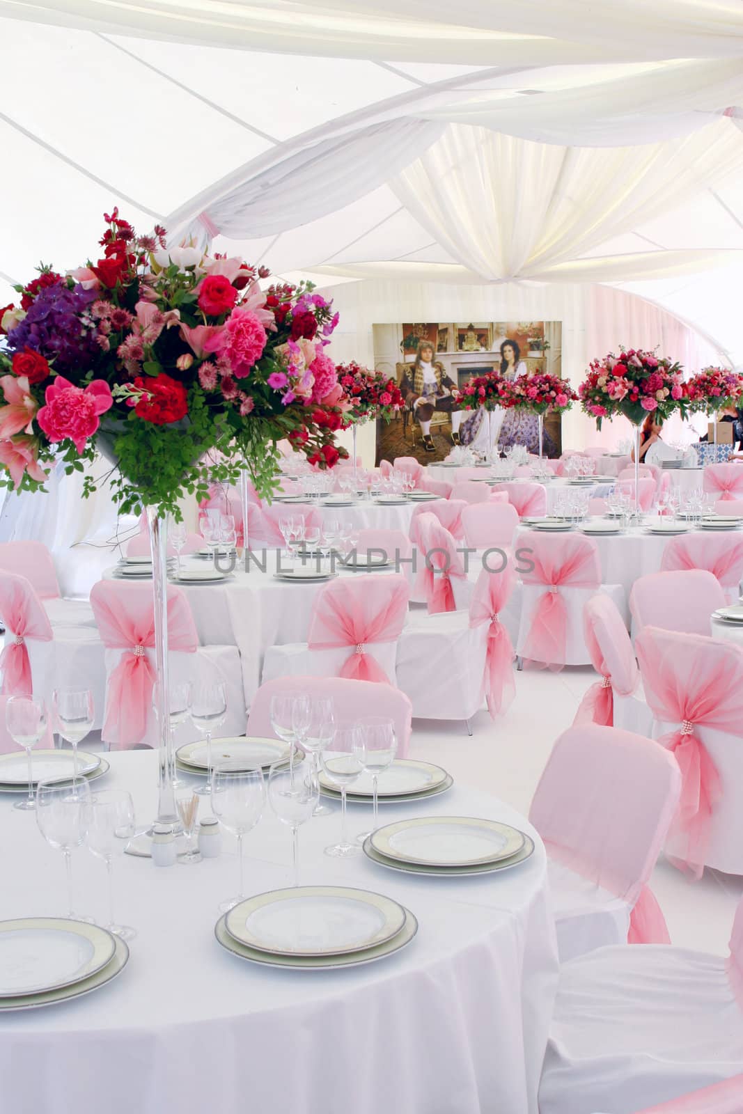 The wedding table decorated by pink colors and flowers