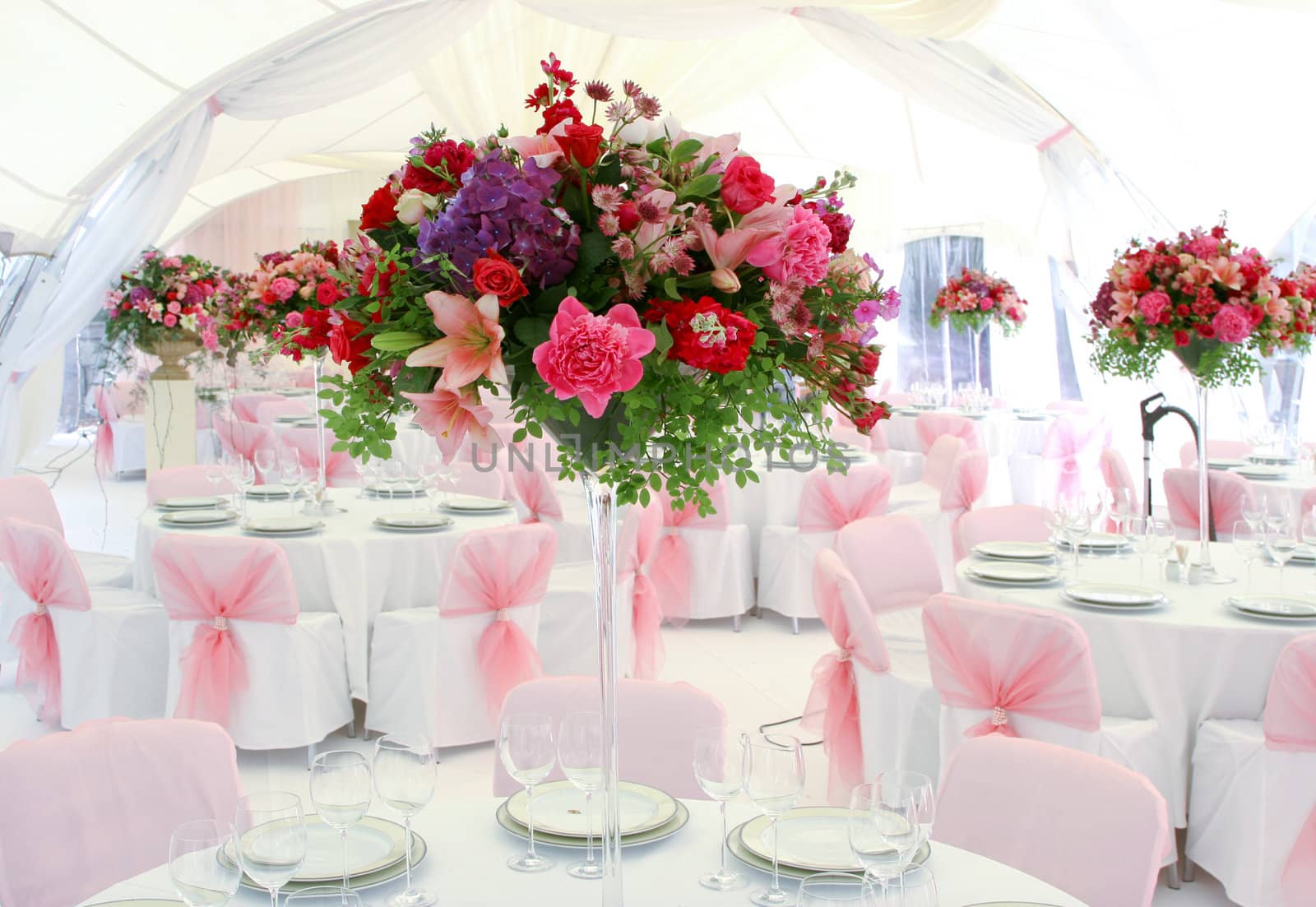 The wedding table decorated by pink colors and flowers