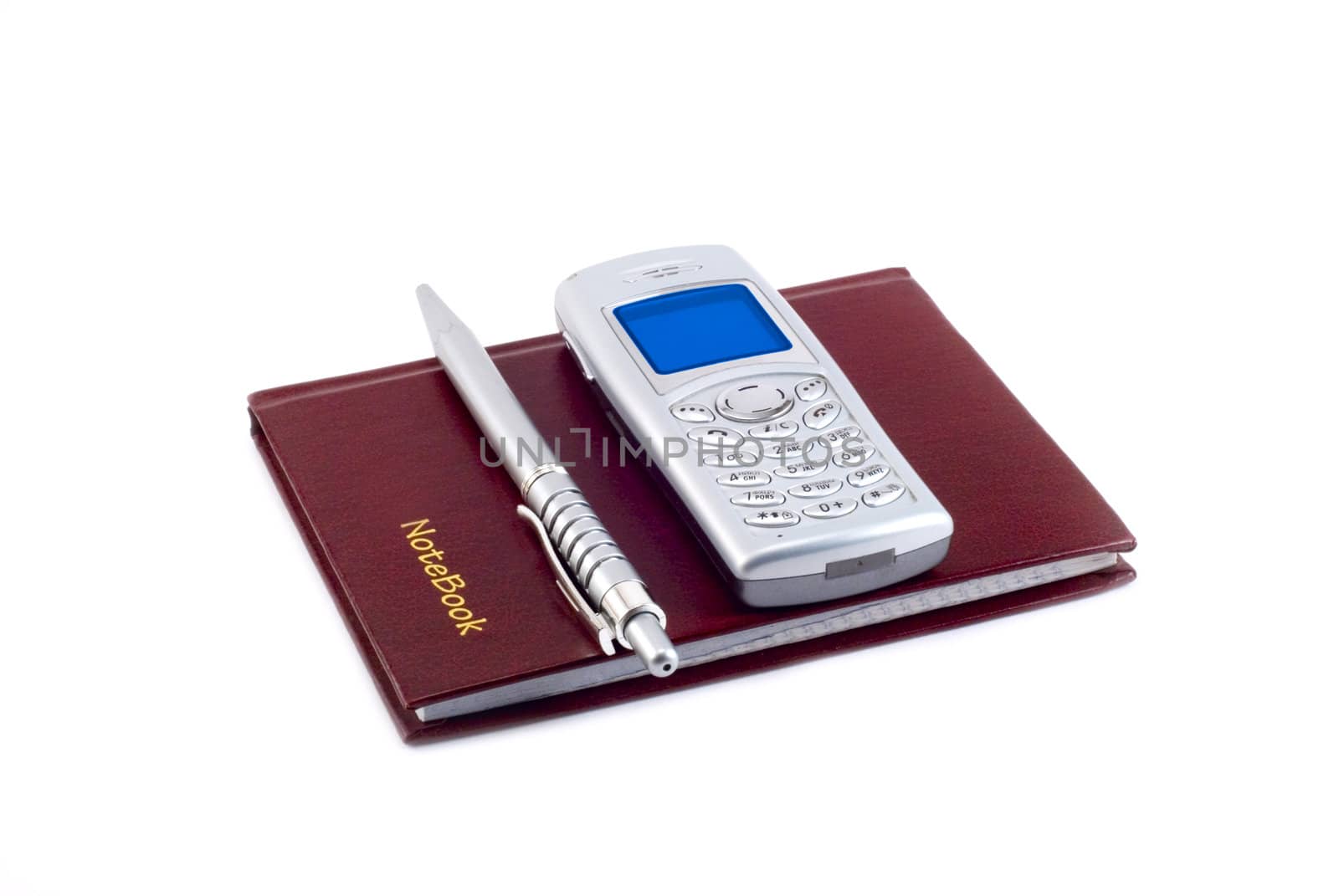 The notebook, the pen and mobile phone are photographed on a white background