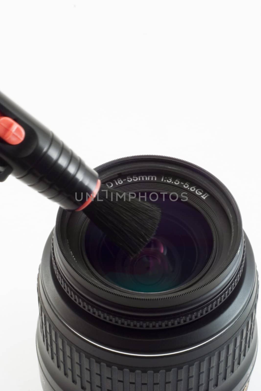 The object-glass with brush photographed on a white background