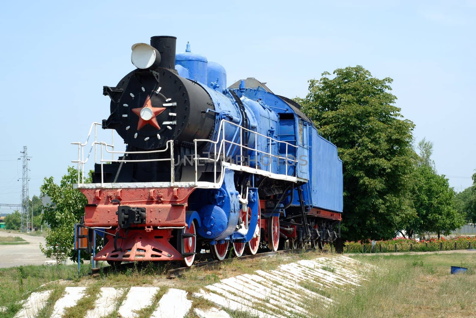 The ancient steam locomotive stands on a pedestal