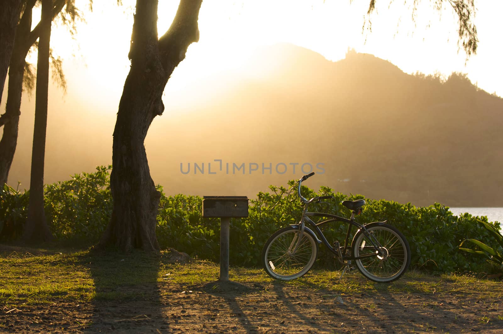 Sunset on Hanalei Bay with Backlit Bike and BBQ.