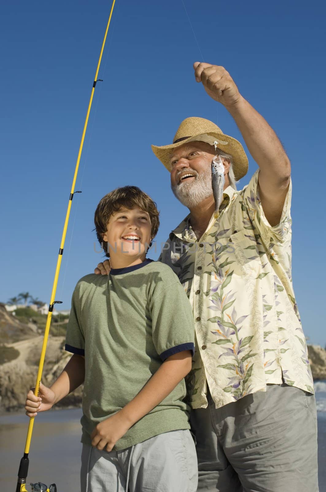 Boy and Grandfather Showing off Fish by moodboard