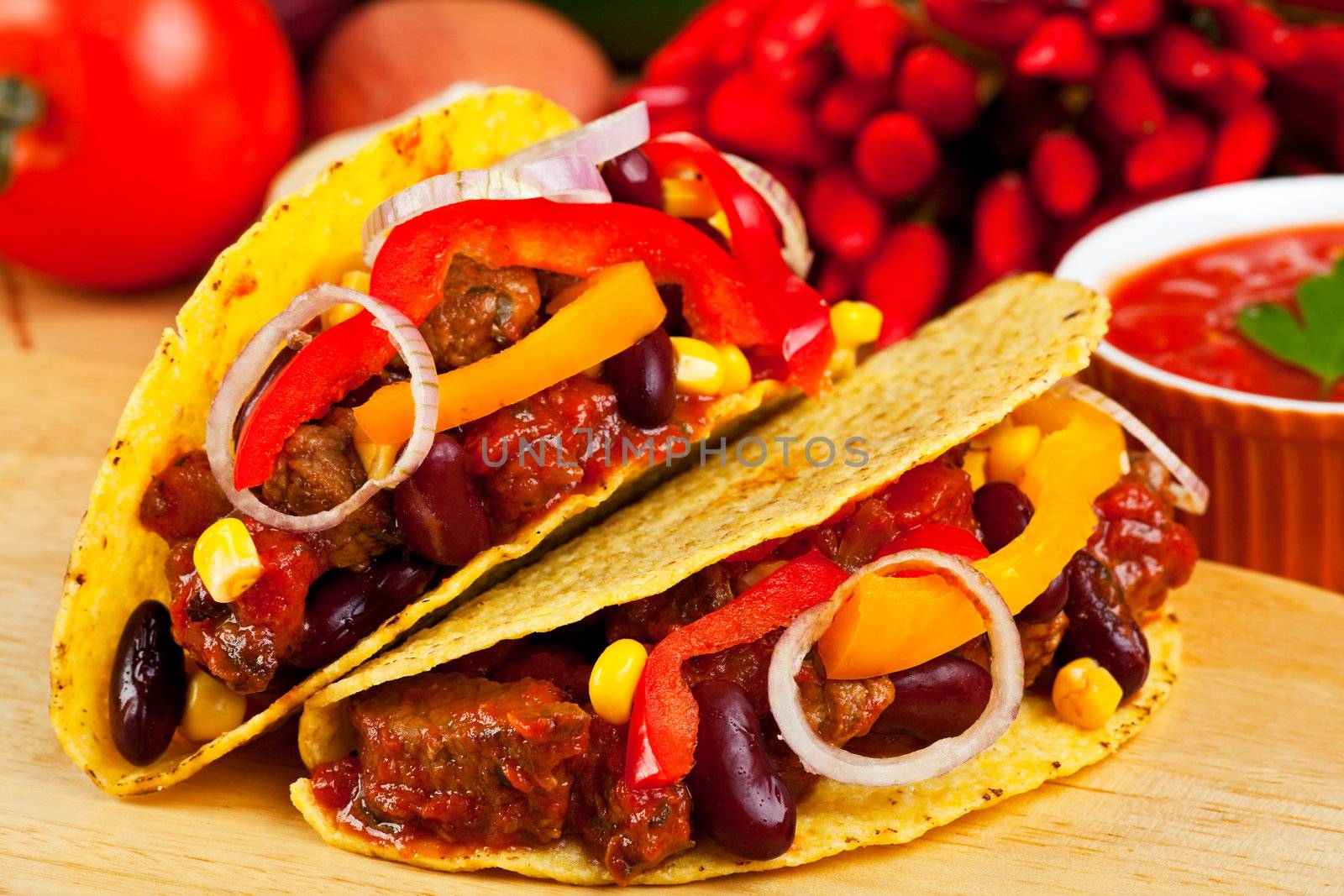 tortilla shells stuffed with meat sauce and beans by bernjuer