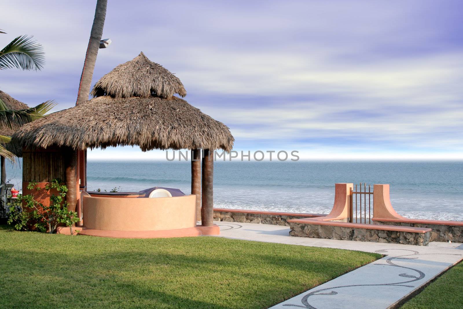 Beautiful beach cabana overlooking ocean in grassy yard