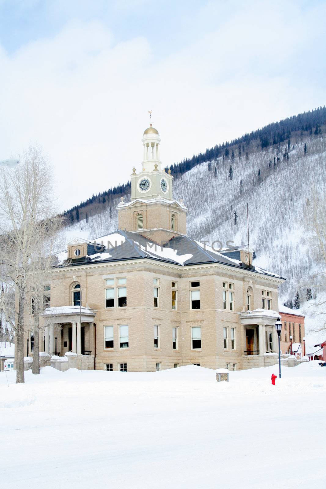 Old town hall in mountains with lots of snow