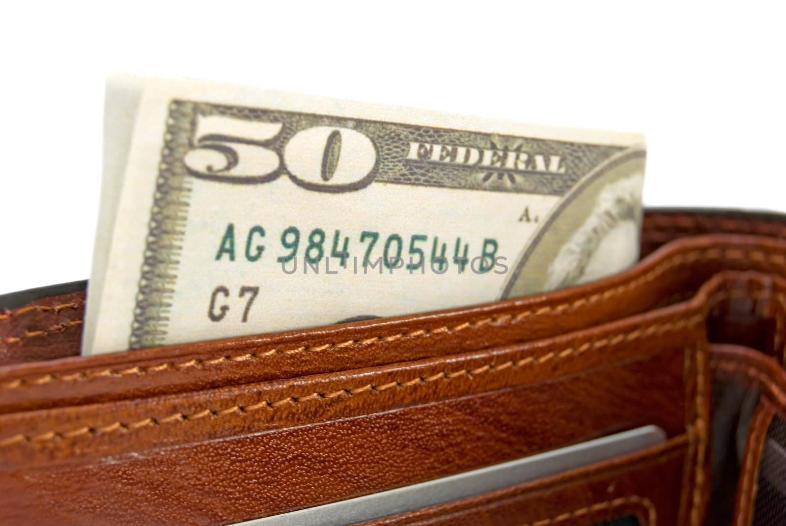 The brown purse with money is photographed  a close-up