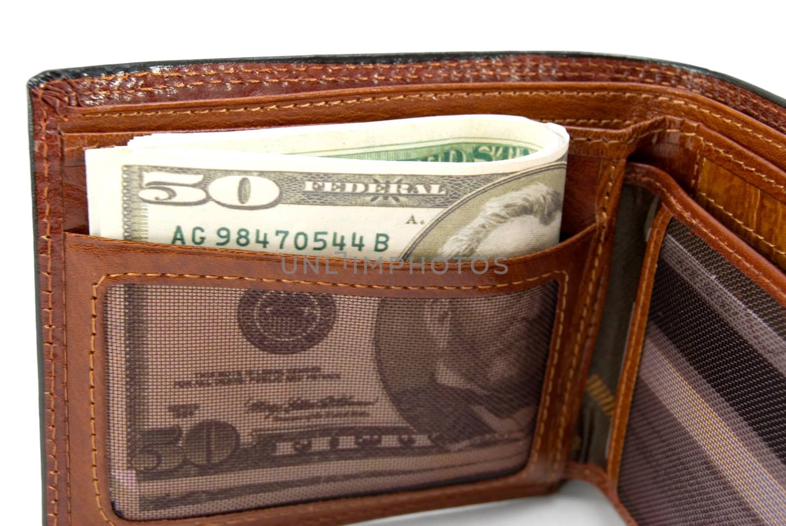 The brown purse with money is photographed a close-up