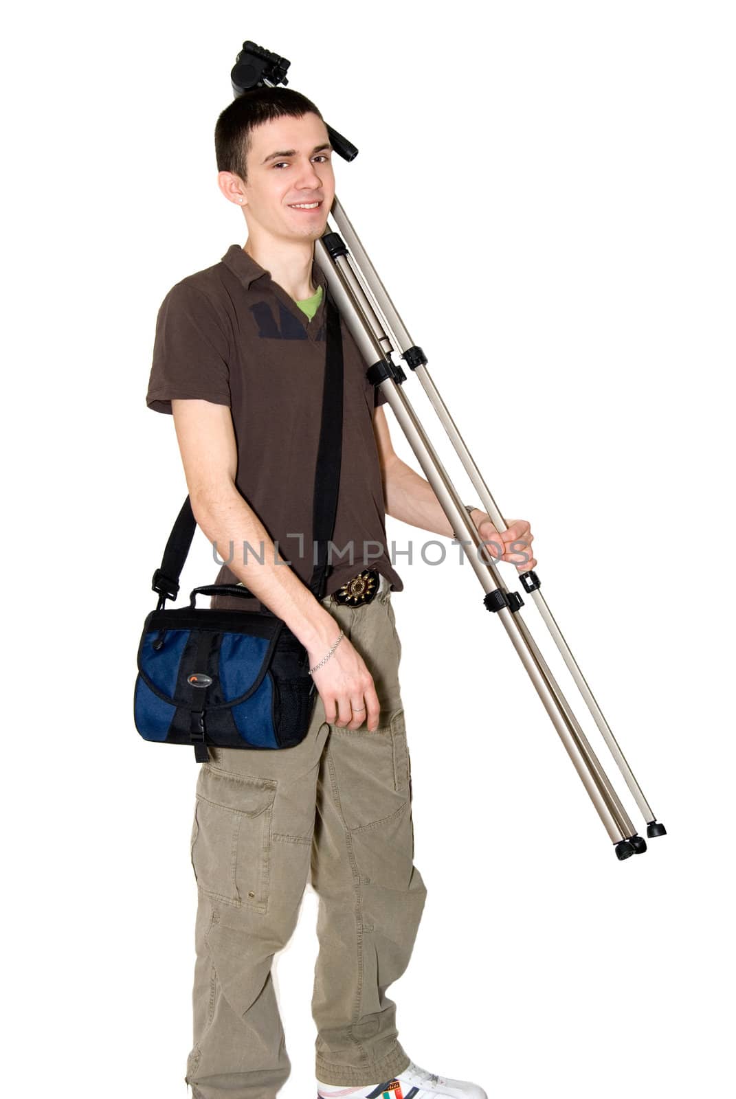 The photographer bears a photo-tripod on a shoulder
