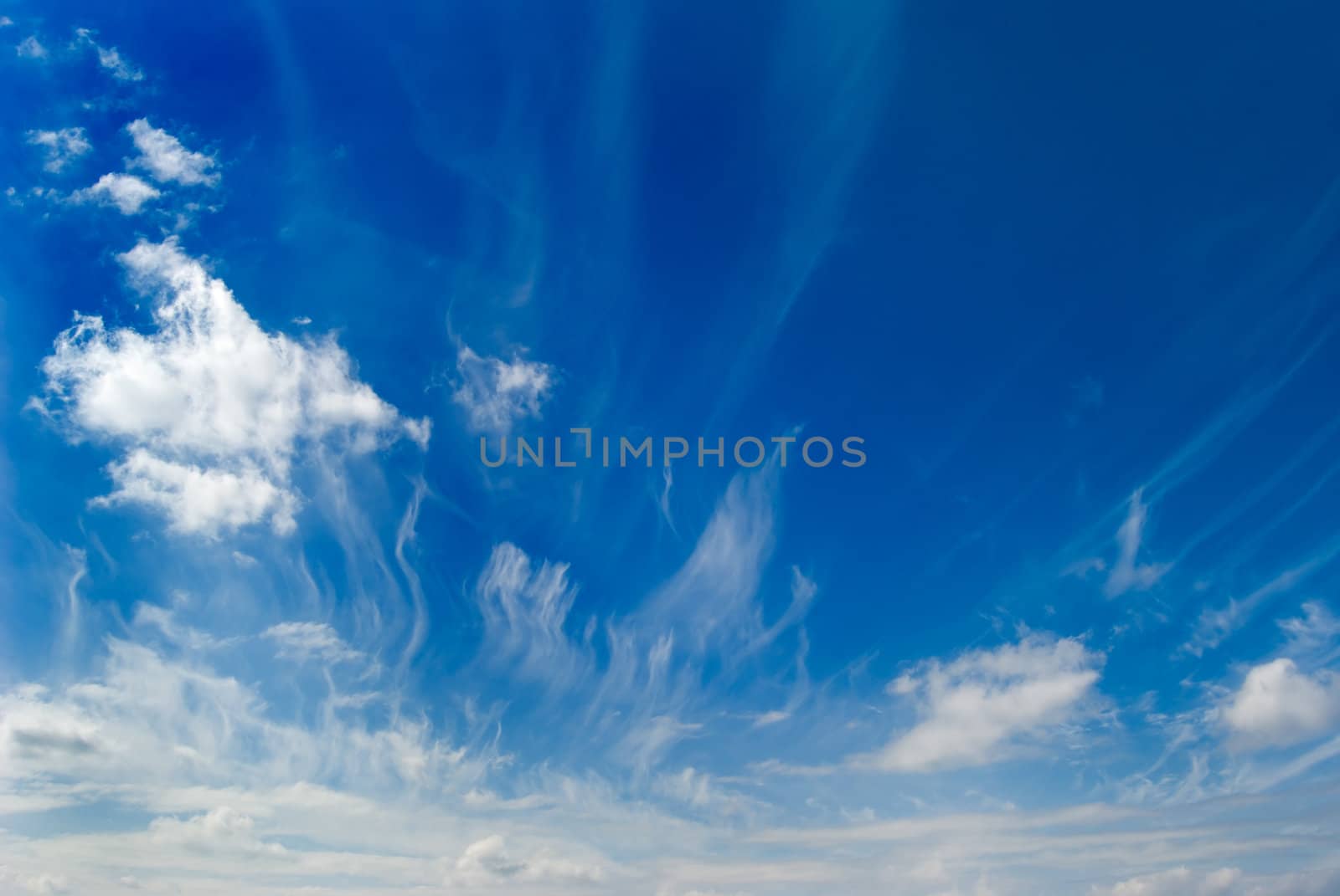 White clouds are photographed on a background of the blue sky