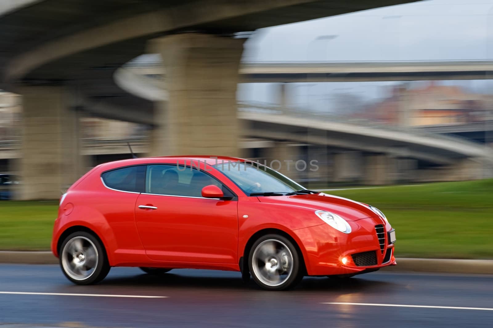 Red car dirving very fast under the bridge, Riga, Latvia