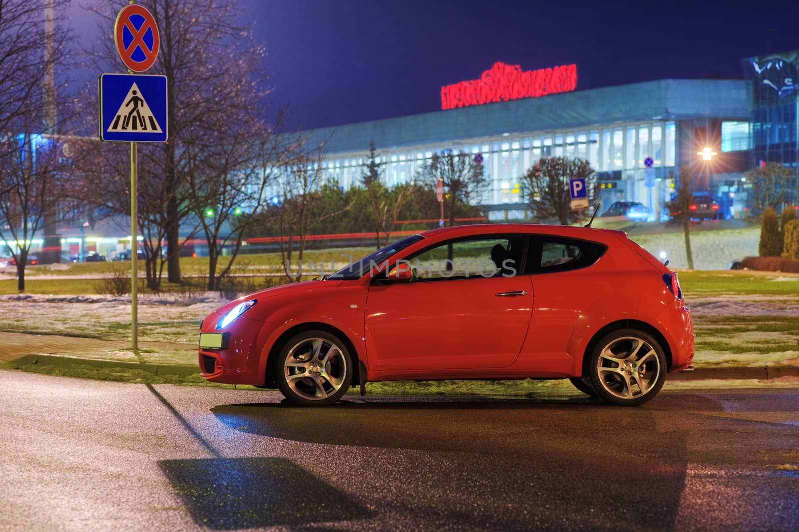 Car at evening near the airport , stoped at pedestrian crossing, Riga, Latvia