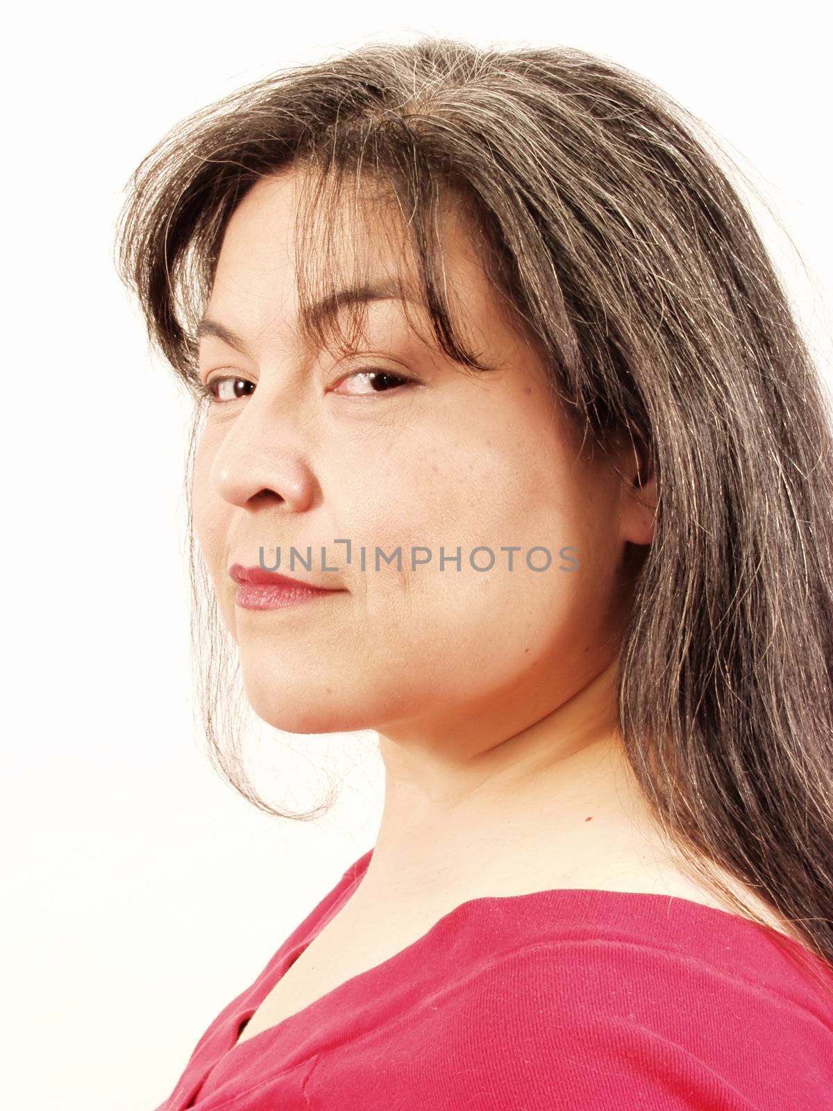 A woman with greying hair takes a sly look at the camera. On an isolated white background.