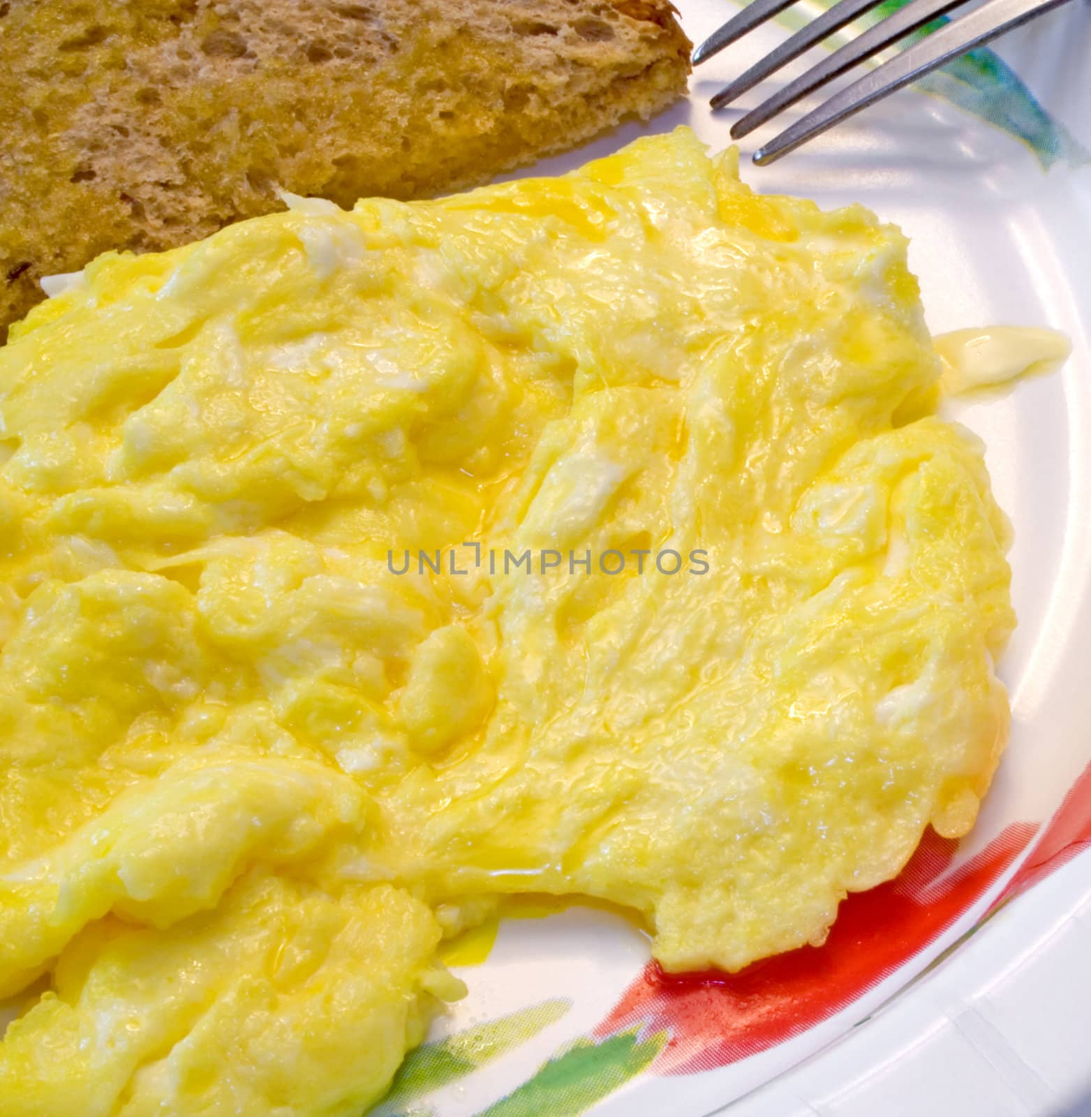 Eggs and toast on paper plate ready to eat or serve